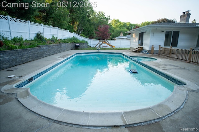 626 Wilwood Rd, Rochester Hills, MI 48309 - view of swimming pool featuring a patio area, entry steps, a fenced backyard, and a pool with connected hot tub