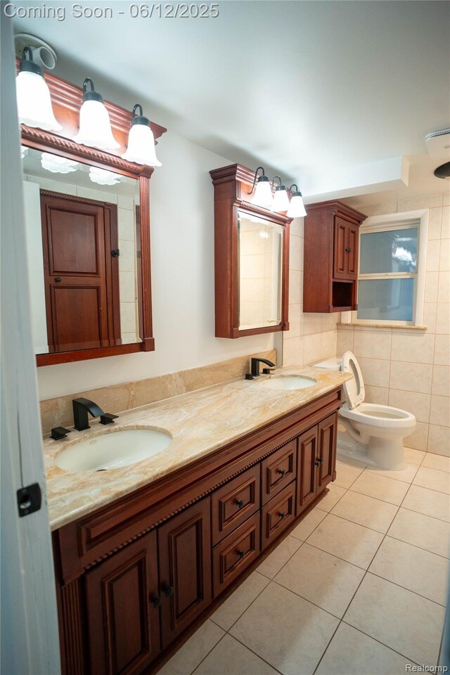626 Wilwood Rd, Rochester Hills, MI 48309 - bathroom with tile patterned flooring, double vanity, tile walls, and toilet