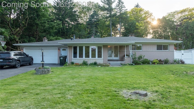 626 Wilwood Rd, Rochester Hills, MI 48309 - ranch-style home featuring brick siding, an attached garage, asphalt driveway, and a chimney