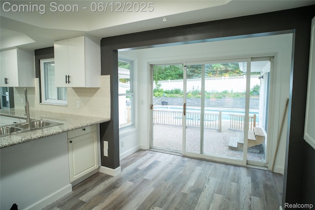626 Wilwood Rd, Rochester Hills, MI 48309 - kitchen featuring light wood finished floors, white cabinets, and a sink