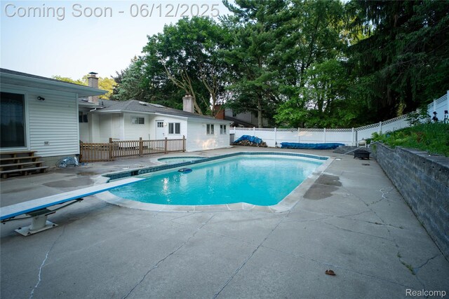 626 Wilwood Rd, Rochester Hills, MI 48309 - view of swimming pool with a jacuzzi, a patio, a fenced backyard, and a diving board