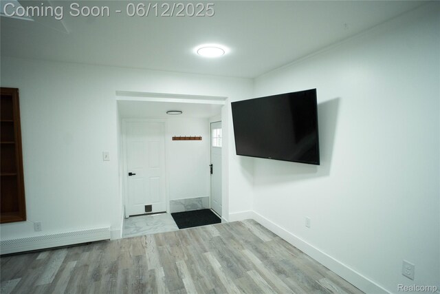 626 Wilwood Rd, Rochester Hills, MI 48309 - unfurnished living room with a baseboard radiator, wood finished floors, and baseboards