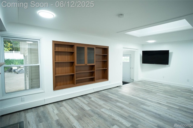 626 Wilwood Rd, Rochester Hills, MI 48309 - spare room featuring wood finished floors, a smoke detector, baseboards, and plenty of natural light