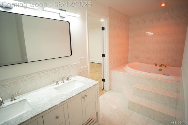 626 Wilwood Rd, Rochester Hills, MI 48309 - full bath featuring tile patterned floors, a tub with jets, double vanity, and tile walls