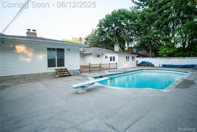 626 Wilwood Rd, Rochester Hills, MI 48309 - view of pool with a patio area, a fenced backyard, entry steps, a diving board, and a jacuzzi