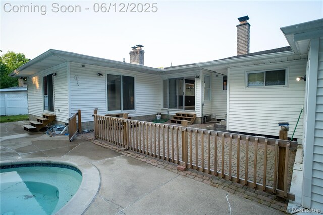 626 Wilwood Rd, Rochester Hills, MI 48309 - back of house with entry steps, a chimney, and a patio