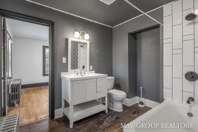 1951 Leonard St NW, Grand Rapids, MI 49504 - full bathroom featuring toilet, vanity, shower / washtub combination, and baseboards