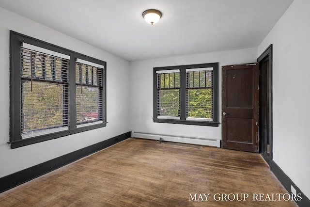 1951 Leonard St NW, Grand Rapids, MI 49504 - unfurnished room with a baseboard radiator, wood finished floors, and baseboards