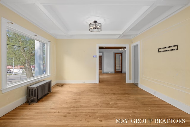 1951 Leonard St NW, Grand Rapids, MI 49504 - unfurnished room with radiator heating unit, light wood finished floors, coffered ceiling, a chandelier, and baseboards