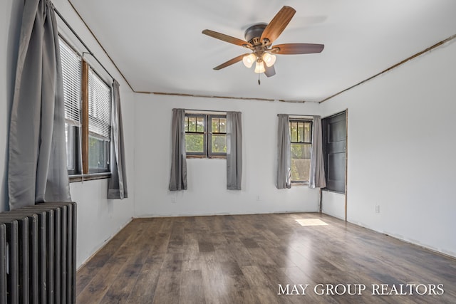 1951 Leonard St NW, Grand Rapids, MI 49504 - spare room featuring radiator heating unit, wood finished floors, and a ceiling fan