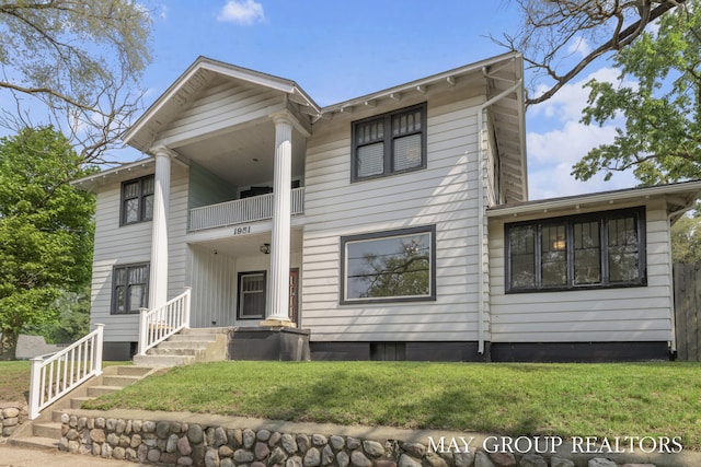 1951 Leonard St NW, Grand Rapids, MI 49504 - neoclassical home featuring a balcony and a front lawn