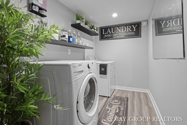1951 Leonard St NW, Grand Rapids, MI 49504 - washroom with washing machine and clothes dryer, light wood-style floors, baseboards, and recessed lighting