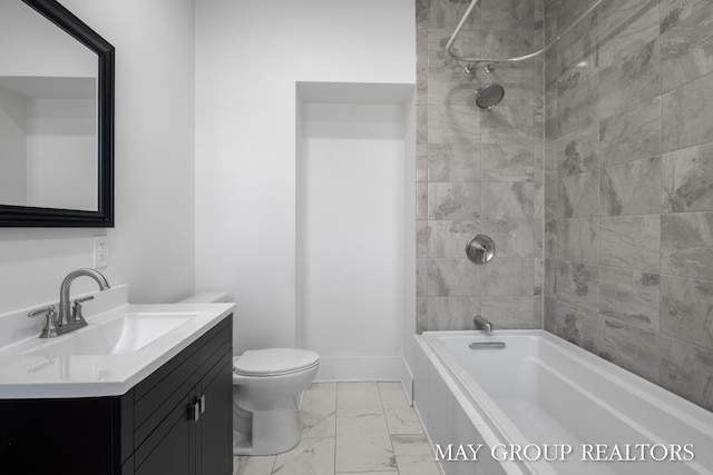 1951 Leonard St NW, Grand Rapids, MI 49504 - bathroom featuring vanity, toilet, marble look tiles, and tiled shower / bath