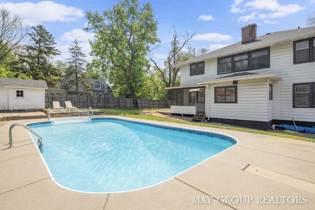 1951 Leonard St NW, Grand Rapids, MI 49504 - view of pool with a sunroom, a fenced backyard, and a patio area