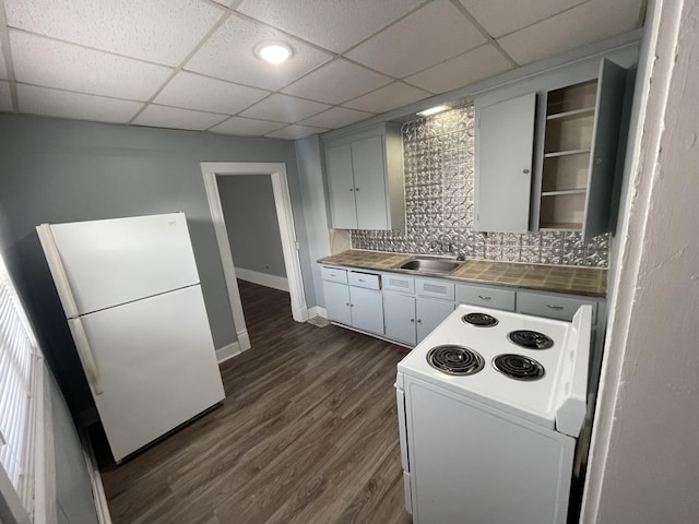 1803 Portage St, Kalamazoo, MI 49001 - kitchen with white appliances, tasteful backsplash, a sink, baseboards, and dark wood-type flooring