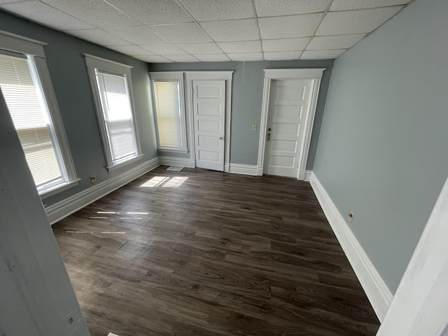 1803 Portage St, Kalamazoo, MI 49001 - spare room with a paneled ceiling, dark wood-style floors, and baseboards