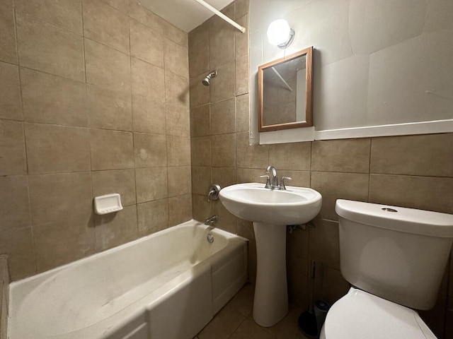 1803 Portage St, Kalamazoo, MI 49001 - bathroom featuring toilet, shower / bathtub combination, tile walls, and tile patterned flooring