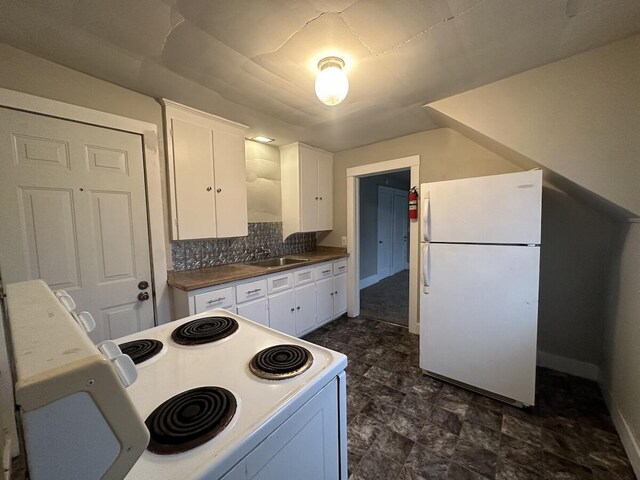 1803 Portage St, Kalamazoo, MI 49001 - kitchen featuring white appliances, a sink, white cabinetry, and baseboards