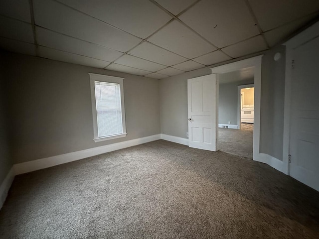 1803 Portage St, Kalamazoo, MI 49001 - empty room featuring a paneled ceiling, carpet flooring, and baseboards