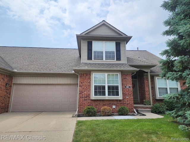 5659 Victory Cir, Sterling Heights, MI 48310 - view of front of property with brick siding, a shingled roof, concrete driveway, and a garage