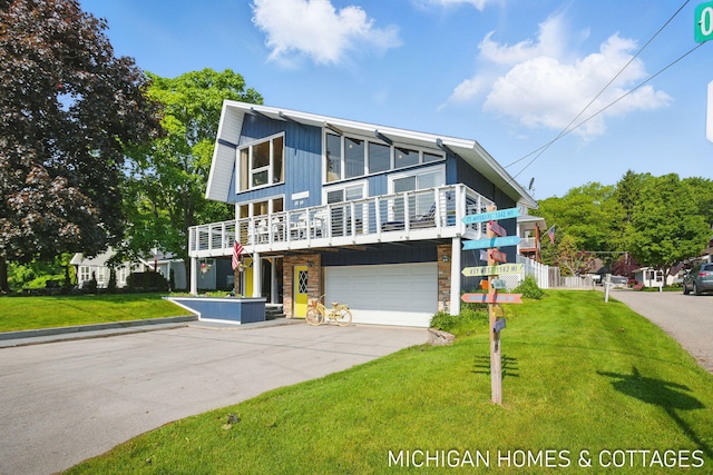 2259 Ottawa Beach Rd, Holland, MI 49424 - view of front facade with driveway, a front lawn, a garage, and a balcony
