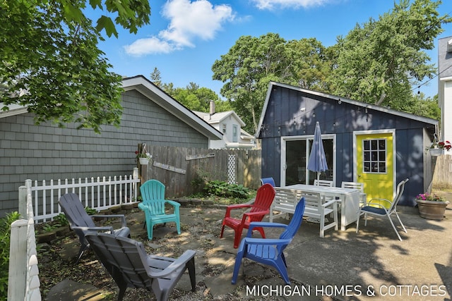 2259 Ottawa Beach Rd, Holland, MI 49424 - back of property with a patio area, an outdoor fire pit, and an outdoor structure