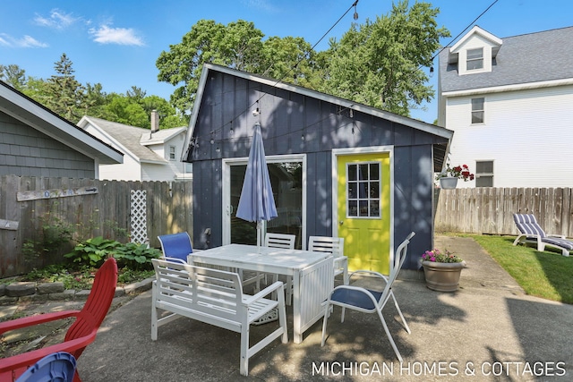 2259 Ottawa Beach Rd, Holland, MI 49424 - view of patio featuring outdoor dining area and an outdoor structure