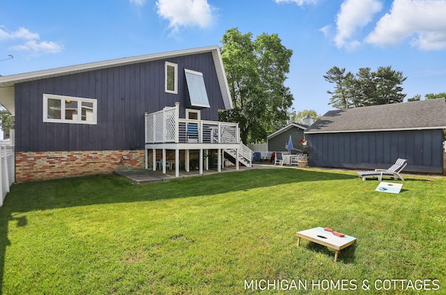2259 Ottawa Beach Rd, Holland, MI 49424 - back of property with stairway, a wooden deck, and a yard