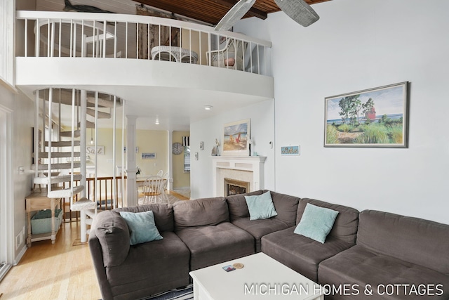 2259 Ottawa Beach Rd, Holland, MI 49424 - living area featuring light wood-type flooring, a high ceiling, and a fireplace