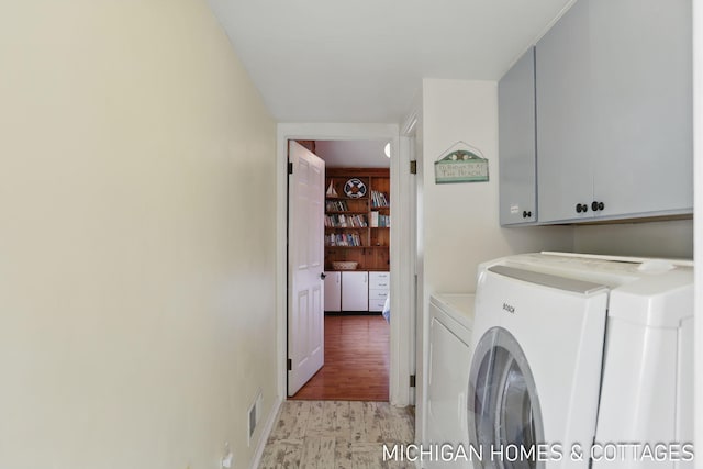 2259 Ottawa Beach Rd, Holland, MI 49424 - laundry room featuring cabinet space and washer and clothes dryer