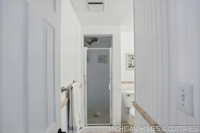 2259 Ottawa Beach Rd, Holland, MI 49424 - bathroom featuring tile walls, a stall shower, and toilet