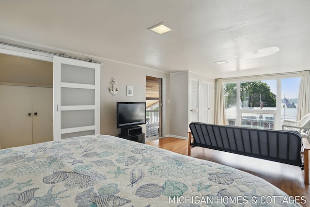 2259 Ottawa Beach Rd, Holland, MI 49424 - bedroom featuring wood finished floors, baseboards, and ornamental molding