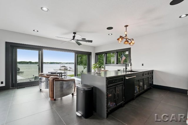 8676 Cherry Point Dr, Manitou Beach, MI 49253 - kitchen with dishwasher, a sink, recessed lighting, dark cabinets, and pendant lighting