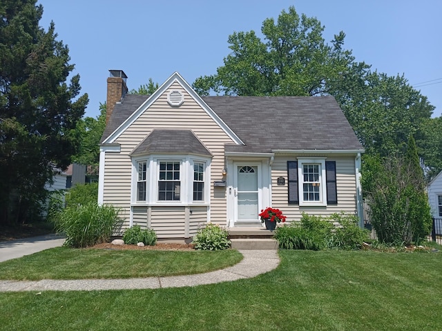 2147 Academy Dr NE, Grand Rapids, MI 49503 - view of front facade featuring a chimney, a front yard, and roof with shingles