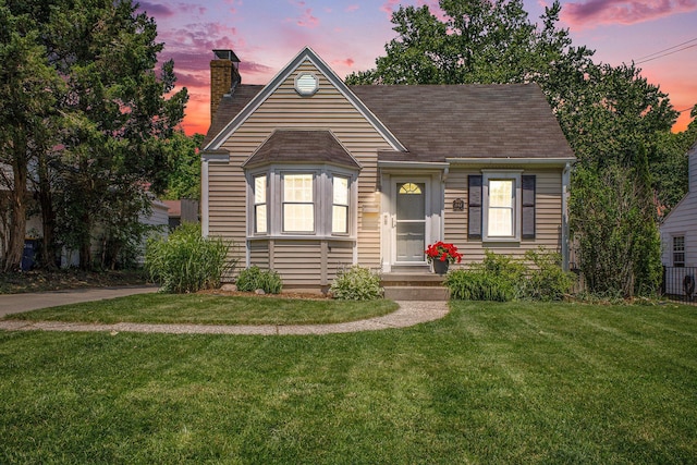 2147 Academy Dr NE, Grand Rapids, MI 49503 - view of front of house featuring a yard, a chimney, and a shingled roof