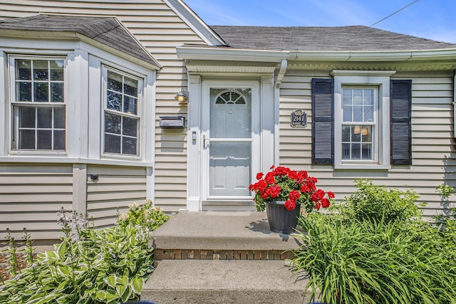 2147 Academy Dr NE, Grand Rapids, MI 49503 - view of exterior entry featuring roof with shingles