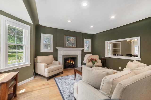 2147 Academy Dr NE, Grand Rapids, MI 49503 - living room featuring plenty of natural light, baseboards, a fireplace, a chandelier, and recessed lighting