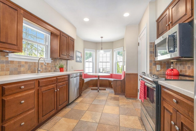 2147 Academy Dr NE, Grand Rapids, MI 49503 - kitchen featuring stainless steel appliances, a sink, brown cabinets, and recessed lighting