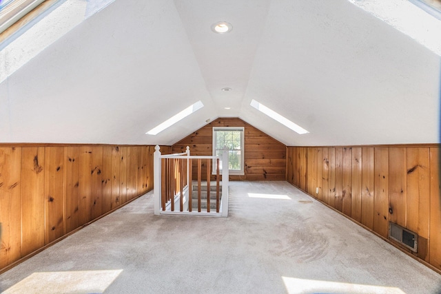 2147 Academy Dr NE, Grand Rapids, MI 49503 - bonus room featuring a skylight, wood walls, vaulted ceiling, and carpet