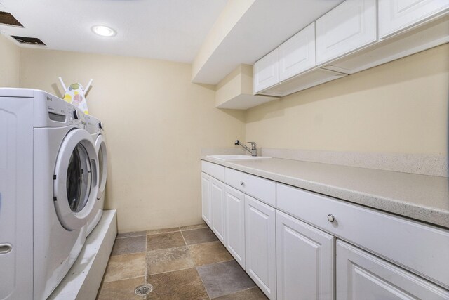 2147 Academy Dr NE, Grand Rapids, MI 49503 - laundry area with washing machine and dryer, recessed lighting, light stone finish flooring, and cabinet space