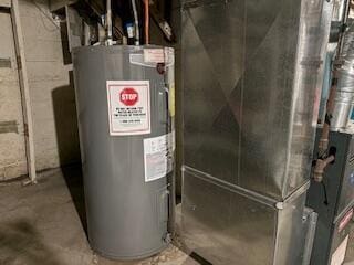 14882 Littlefield St, Detroit, MI 48227 - utility room featuring electric water heater and heating unit