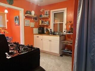 14882 Littlefield St, Detroit, MI 48227 - kitchen with white cabinetry, open shelves, and gas stove