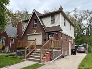 14882 Littlefield St, Detroit, MI 48227 - view of front of house with a garage, driveway, a chimney, and a front yard