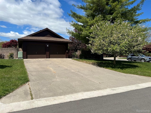2205 Hammond Place Ctr, Traverse City, MI 49686 - view of front of home with a front lawn, driveway, a garage, and a shingled roof