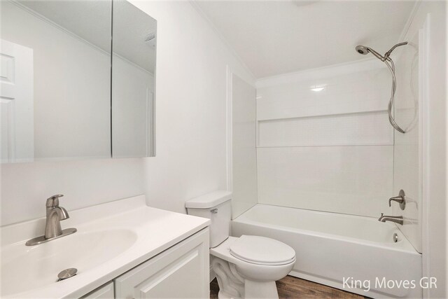 11690 21 Mile Rd NE, Sand Lake, MI 49343 - bathroom featuring toilet, bathtub / shower combination, vanity, and wood finished floors