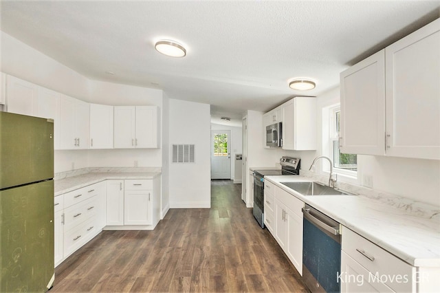 11690 21 Mile Rd NE, Sand Lake, MI 49343 - kitchen with appliances with stainless steel finishes, a sink, dark wood finished floors, and white cabinets