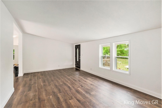 11690 21 Mile Rd NE, Sand Lake, MI 49343 - spare room with dark wood-type flooring and baseboards
