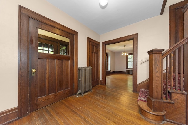 1706 S University Ave, Ann Arbor, MI 48104 - foyer with radiator heating unit, hardwood / wood-style floors, a chandelier, and stairway
