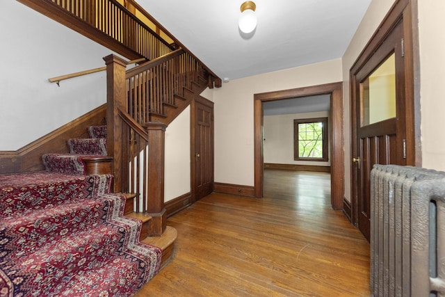 1706 S University Ave, Ann Arbor, MI 48104 - stairway with radiator heating unit, wood finished floors, and baseboards