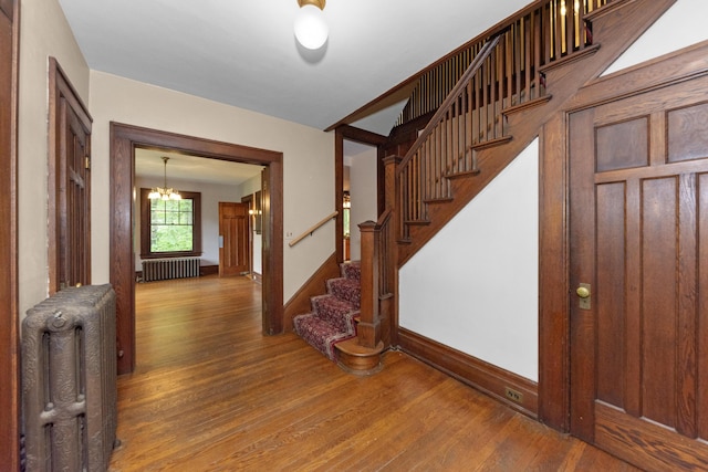 1706 S University Ave, Ann Arbor, MI 48104 - entrance foyer featuring radiator heating unit, wood finished floors, stairs, and a chandelier